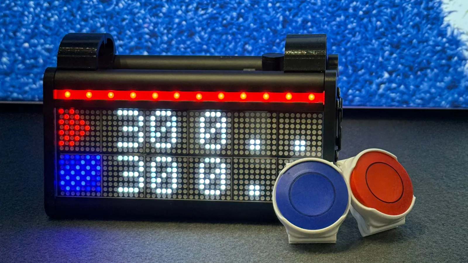 The LedsCount Go scoreboard with the red and blue wearable RF remotes.